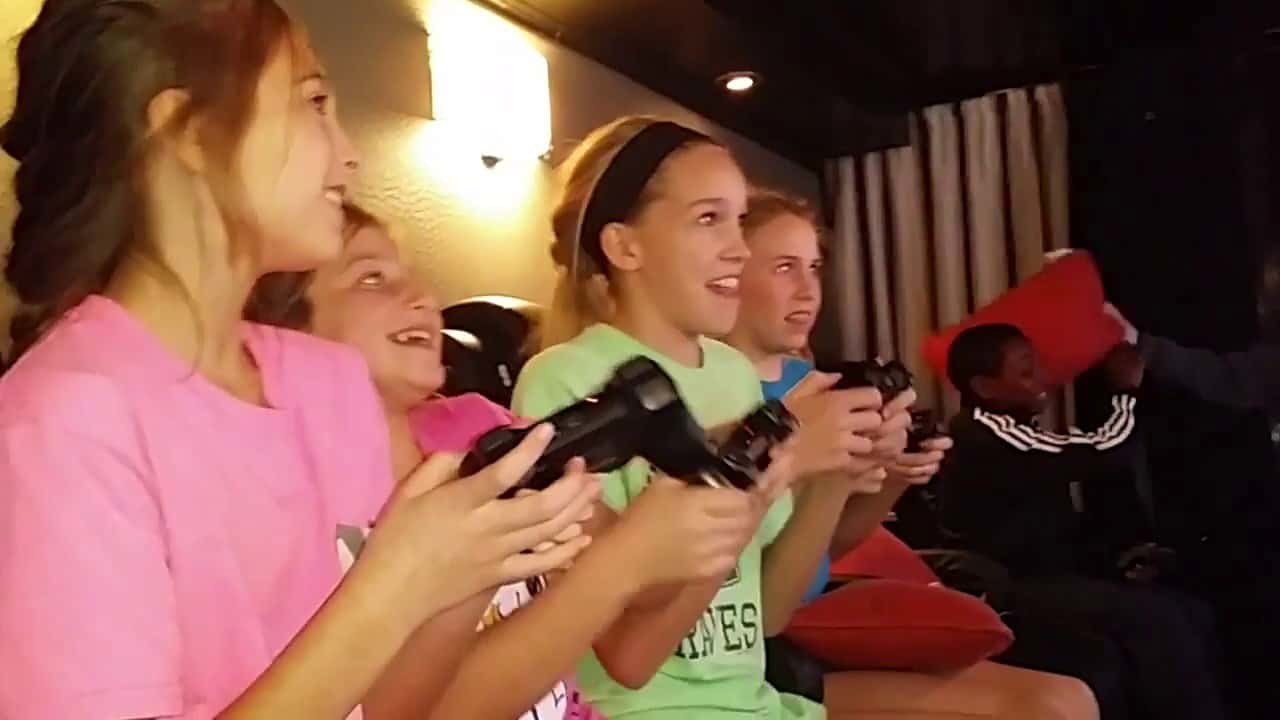 4 girls playing traditional video games.