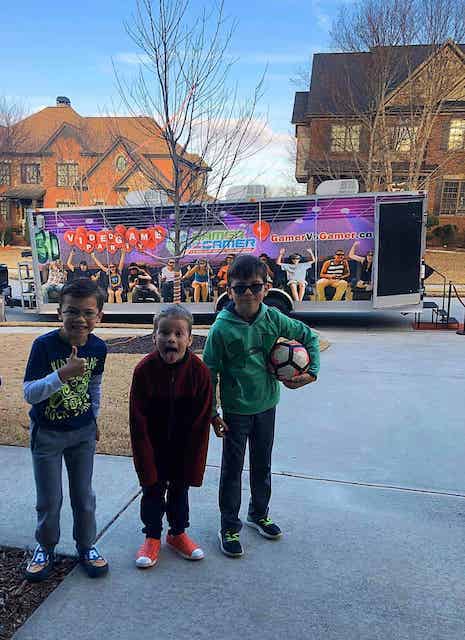 3 boys getting ready to go inside the Game Bus Rental provided by the Gamer vs Gamer company