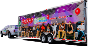 Image of a Game Truck attached to pickup truck. Both Wrapped in Gamer vs Gamer company information. This promotes our game truck rentals